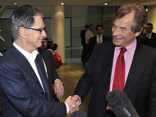 John Henry, left, the financier who heads New England Sports Ventures, owners of the Boston Red Sox, and Liverpool's soccer club chairman Martin Broughton shake hands at a lawyers office in London, Friday, Oct. 15, 2010, where Liverpool FC's club directors are meeting. (AP Photo/Lennart Preiss)