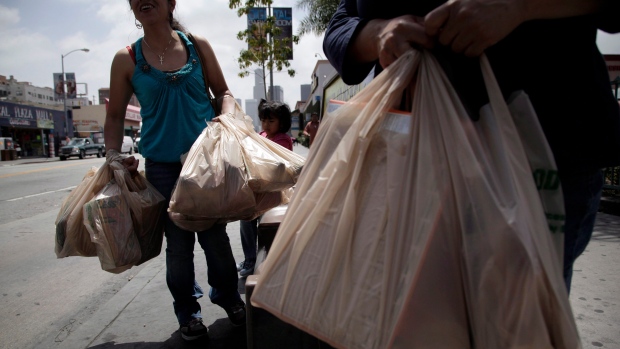 Women walk with plastic shopping bags