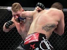 Cain Velasquez, right, lands a left to the face of Brock Lesnar during a UFC mixed martial arts match in Anaheim, Calif., Saturday, Oct. 23, 2010. Velasquez won by TKO in the first round. (AP Photo/Jae C. Hong)