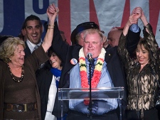 Toronto Mayor-elect Rob Ford, centre, raises his arms with his wife Renata, right, and mother Diane, left, as he speaks to supporters in Toronto on Monday, October 25, 2010. (THE CANADIAN PRESS/Nathan Denette)