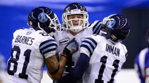 Toronto Argonauts' Chad Kackert, centre, celebrates a touchdown against the Montreal Alouettes' with teammates Dontrelle Inman, right, and Jason Barnes during second half football action in the CFL Eastern Final on Sunday, Nov, 18, 2012 in Montreal. (THE CANADIAN/Paul Chiasson