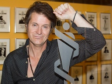 Jim Cuddy of the group Blue Rodeo poses by a Juno awards logo in Toronto on Tuesday October 25, 2010. (THE CANADIAN PRESS/Frank Gunn)