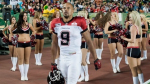 Calgary Stampeders player Jon Cornish makes his way back to the bench after scoring the winning touchdown and dancing with the team's cheerleaders during the fourth quarter of a CFL game against the Edmonton Eskimos in Edmonton on Friday, Sept. 7, 2012. (The Canadian Press/John Ulan)