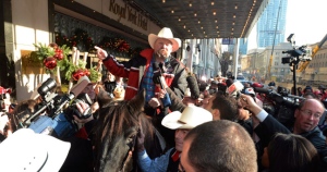Reporters and photographers surround a Calgary Stampeder rider and horse outside the Royal York Hotel in Toronto on Thursday Nov. 22, 2012. By tradition, the Stampeders try to sneak a horse in a hotel when the team vies for the Grey Cup. THE CANADIAN PRESS/Ryan Remiorz