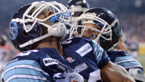 Toronto Argonauts running back Andre Durie celebrates his touchdown against the Calgary Stampeders with teammate Chad Owens during fourth quarter CFL Grey Cup action Sunday November 25, 2012 in Toronto. (Sean Kilpatrick/ THE CANADIAN PRESS)