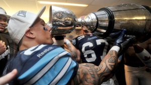 Toronto Argonauts slotback Chad Owens drinks from the Grey Cup as he celebrates the team's championship victory against the Calgary Stampeders on Sunday, Nov. 25, 2012, in Toronto. (The Canadian Press/Nathan Denette)