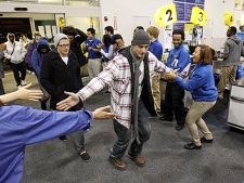 Andrew Lapchynski, 22, is greeted by employees as he enters Best Buy Friday, Nov. 26, 2010, in Mayfield Heights, Ohio. Lapchynski came into the store to buy a television. (AP Photo/Tony Dejak)