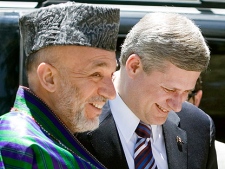 Afghan President Hamid Karzai and Canadian Prime Minister Stephen Harper share a laugh upon his arrival at the Presidential palace in Kabul Afghanistan Tuesday May 22, 2007. (CP PHOTO/Tom Hanson) 