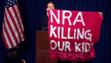 A protester interrupts NRA press conference