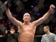 Georges St-Pierre, from Montreal celebrates after defeating Josh Koscheck, from Waynesburg, PA., with a unanimous decision to retain his welterweight title at UFC 124 Sunday, December 12, 2010 in Montreal. 