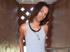 In this file photo taken Aug. 27, 2010, Antoine Dodson, 24, poses in the stairwell of the apartment complex where his sister was attacked in Huntsville, Ala. Dodson's angry, head-shaking TV interview about an attempted rape against his younger sister in her home has turned into a chart-topping iTunes song. (AP Photo/Bob Farley, file)