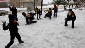 Syrian refugee children have a snowball fight in the mountain town of Bhamdoun, Lebanon on Wednesday, Jan. 9, 2013. (AP Photo/Bilal Hussein)