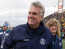 Toronto Argonauts head coach Jim Barker smiles as he walks off the field after the Argos defeated the Hamilton Tiger-Cats in CFL Eastern Conference Semi-Final action in Hamilton, Ontario on Sunday November 14, 2010. (THE CANADIAN PRESS/Frank Gunn)