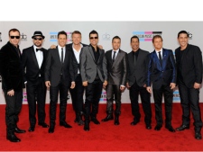 In this Nov. 21, 2010 file photo, members of the Backstreet Boys and New Kids on the Block, from left, Donnie Wahlberg, A. J. McLean, Joey McIntyre, Nick Carter, Jordan Knight, Howie Dorough, Danny Wood, Brian Thomas Littrell, and Jonathan Knight, arrive at the 38th Annual American Music Awards in Los Angeles. (AP Photo/Chris Pizzello, file)