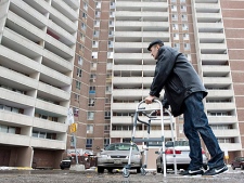 Uzbek refugee Dilshod Marupov, 22, uses a walker in front of a Toronto apartment building Friday, December 17, 2010 where he was almost killed in an industrial accident a year ago. Marupov is the lone survivor of a scaffold collapse that killed four migrant workers last Christmas Eve. (THE CANADIAN PRESS/Darren Calabrese)