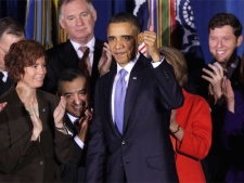 U.S. President Barack Obama gives a 'thumbs-up' sign after signing the Don't Ask, Don't Tell Repeal Act of 2010, Wednesday, Dec. 22, 2010, at the Interior Department in Washington. 