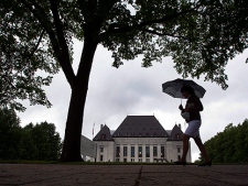 A pedestrian walks past the Supreme Court of Canada in Ottawa on Thursday June 10, 2010. (THE CANADIAN PRESS/Sean Kilpatrick)