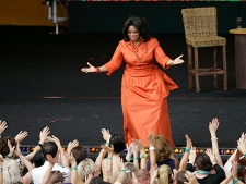 In this Dec. 14, 2010 file photo, American talk show host Oprah Winfrey is greeted by fans during the filming of "Oprah's Ultimate Australian Adventure" at the Sydney Opera House in Sydney. Fresh off her Australian tour with her frenzied talk-show fans, Winfrey is taking a respite in the South Pacific island nation of Fiji, where the military regime wished her "a great time." (AP Photo/Jeremy Piper, File)
