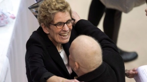 Ontario Liberal Party leadership candidate Kathleen Wynne hugs a delegate as she registers to vote at the leadership convention in Toronto on Friday, Jan. 25, 2013. (The Canadian Press/Frank Gunn)