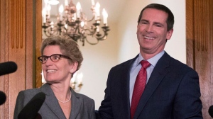 Outgoing Premier Dalton McGuinty, right, and premier-designate Kathleen Wynne pose for the media after a meeting at Queen's Park in Toronto on Monday, Jan. 28, 2013. (The Canadian Press/Chris Young)