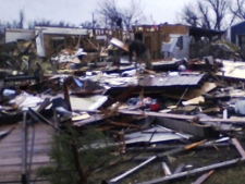 In this photo taken with a cell phone, damage to a barn and a house is shown in Cincinnati, Ark., Friday, Dec. 31, 2010. (AP Photo/Siloam Springs Herald Leader via The Benton County Daily Record, Melissa Gute)