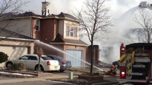 Firefighters battle a blaze on Beaconsfield Avenue in Brampton on Friday, Feb. 1, 2013. (Tamara Cherry/CTV)