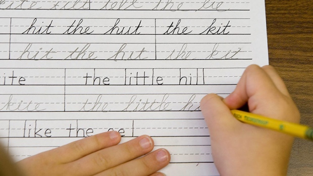 Child practices cursive writing