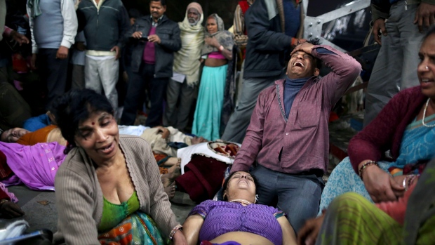 Indian man weeps for a relative killed in stampede