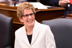 Ontario Premier Kathleen Wynne reacts as Lieutenant Governor David Onley delivers the throne speech at the Ontario Legislature in Toronto on Tuesday, Feb. 19, 2013, (The Canadian Press/Chris Young)