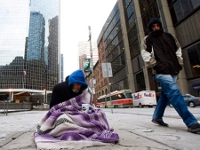 A homeless person panhandles for money during an extreme cold weather alert for the City of Toronto on Monday, December 13, 2010. (THE CANADIAN PRESS/Nathan Denette)