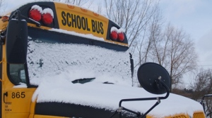 School bus covered in snow