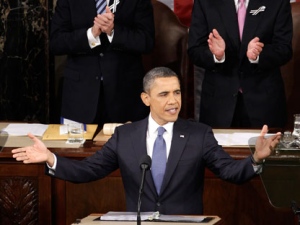 President Barack Obama gestures on Capitol Hill in Washington, Tuesday, Jan. 25, 2011, prior to delivering his State of the Union address in Washington, Tuesday, Jan. 25, 2011. Vice President Joe Biden and House Speaker John Boehner of Ohio applaud at rear. (AP Photo/Charles Dharapak)