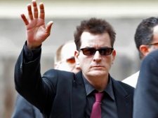 In a Aug. 2, 2010 file photo, Charlie Sheen waves as he arrives at the Pitkin County Courthouse in Aspen, Colo., for a hearing in a domestic abuse case. Sheen was hospitalized in Los Angeles on Thursday, Jan. 27, 2011. (AP/Ed Andrieski)