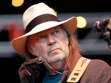 In this Oct. 24, 2010 file photo, Neil Young performs during the Bridge School Benefit concert in Mountain View, Calif.  (AP Photo/Tony Avelar, file)