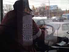 A CP24 viewer submitted this photo on Tuesday of a TTC driver using their BlackBerry while operating the 54 Lawrence Bus. (Alexia Schell - Special to CP24)