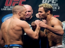 UFC welterweight champion Georges St-Pierre, left, squares off with challenger Josh Koscheck during their weigh-in, as UFC president Dana White, centre, looks on in this Friday, December 10, 2010, file photo. St. Pierre is scheduled to fight at UFC 129 in Toronto on Saturday, April 30, 2011. (THE CANADIAN PRESS/Graham Hughes)