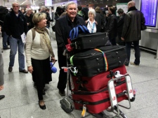 Bill Parent from Toronto and his wife Diane, arrive at the airport in Frankfurt, Germany on Monday, Jan. 31, 2011, after they were flown out of Cairo by German airline Lufthansa. (AP/Michael Probst)