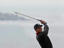 Tiger Woods watches his second shot on the fourth hole of the South Course at Torrey Pines during the final round of the Farmers Insurance Open golf tournament in San Diego on Sunday, Jan. 30, 2011. (AP/Gregory Bull)