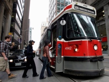 Passengers board a TTC streetcar in downtown Toronto. (THE CANADIAN PRESS/J.P. Moczulski)