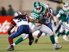 Former Saskatchewan Roughriders slotback Andy Fantuz tries to elude defensive back Jerald Brown during the CFL Grey Cup game Sunday, Nov. 28, 2010 in Edmonton. (THE CANADIAN PRESS/Nathan Denette)