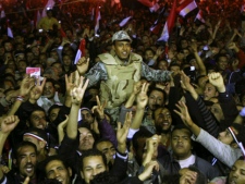 Egyptians celebrate as they carry an army soldier in Tahrir Square after President Hosni Mubarak resigned and handed power to the military in Cairo, Egypt, on Friday, Feb. 11, 2011. (AP Photo/Ahmed Ali)