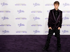 Justin Bieber poses at the premiere of the documentary film "Justin Bieber: Never Say Never," in Los Angeles, Tuesday, Feb. 8, 2011. (AP Photo/Chris Pizzello)