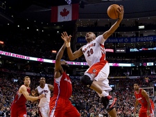 Toronto Raptors' Leandro Barbosa (right) shoots on LA Clippers' Baron Davis during second half NBA basketball action in Toronto on Sunday, February 13, 2011. (THE CANADIAN PRESS/Chris Young)