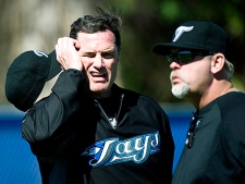 Toronto Blue Jays new Manager John Farrell, left, talks to Blue Jays pitching coach Bruce Walton, right, during spring training in Dunedin, FL, on Monday, Feb. 14, 2011. (THE CANADIAN PRESS/Nathan Denette)