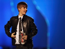 Justin Bieber reacts after receiving the award for International Breakthrough Act at the Brit Awards 2011 at The O2 Arena in London on Tuesday, Feb. 15, 2011. (AP Photo/Joel Ryan)
