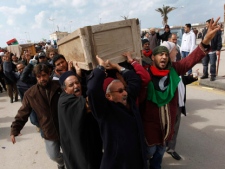 Libyan protesters shout slogans against Libyan Leader Moammar Gadhafi during a demonstration at the court square, in Benghazi, Libya, on Friday Feb. 25, 2011. (AP Photo/Hussein Malla)