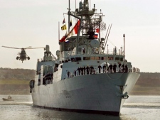 A Sea King helicopter escorts HMCS Charlottetown on the waterfront in Halifax on Wednesday, May 7, 2008, after it returned from a six-month tour of the Persian Gulf. The Canadian navy is sending HMCS Charlottetown to the waters off Libya. (THE CANADIAN PRESS/ Andrew Vaughan)