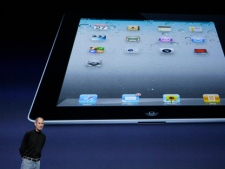 Apple Inc. Chairman and CEO Steve Jobs stands under an image of the iPad 2 at an Apple event at the Yerba Buena Center for the Arts Theater in San Francisco, Wednesday, March 2, 2011. (AP Photo/Jeff Chiu)
