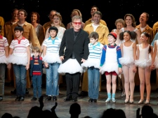 Sir Elton John wears a tutu as he joins the cast of the stage musical 'Billy Elliot' for their curtain call following the show's premiere in Toronto on Tuesday, March 1, 2011. (THE CANADIAN PRESS/Chris Young)