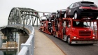 In this June 1, 2009 file photo, a truck loaded with Ford and Lincoln vehicles travels from Canada to the U.S. Peace Bridge border crossing in Buffalo, N.Y. (AP / David Duprey)